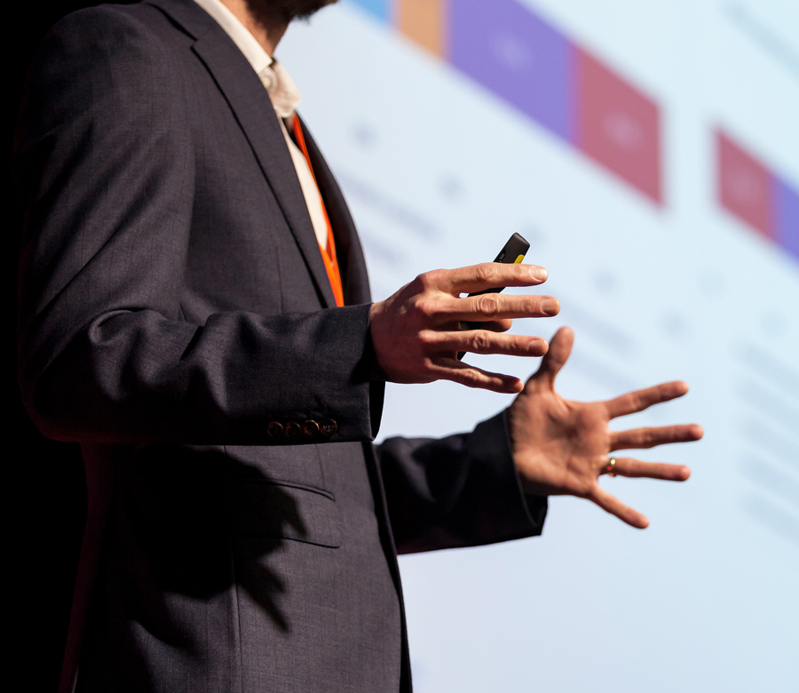 Man in suit giving a presentation.
